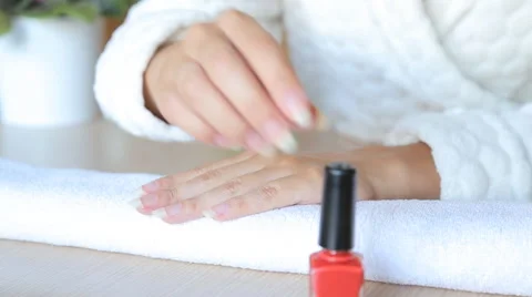 Closeup shot of a beautician applying nail polish to female nail in a nail salon Stock Footage