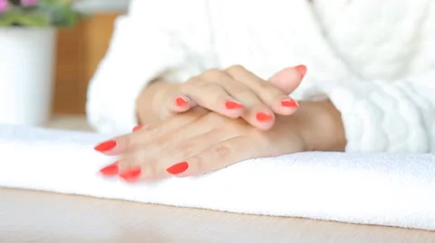 Closeup shot of a beautician applying nail polish to female nail in a nail salon Stock Footage