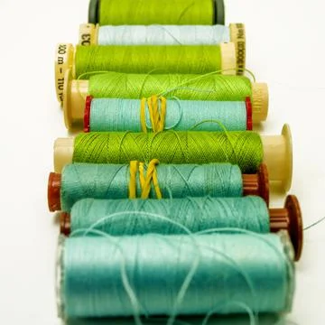 Closeup shot of bobbin of the thread of different green shades Stock Photos