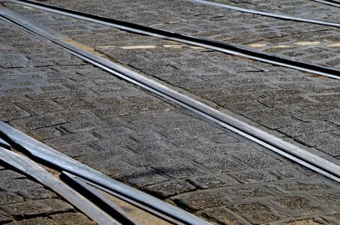 A closeup shot of a brick ground with intersections of train trails - perfect Stock Photos