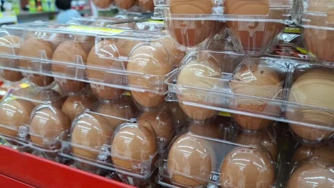 Closeup Shot of Brown Eggs in Plastic Cartons at Grocery Store Stacked High Video stock 296936590