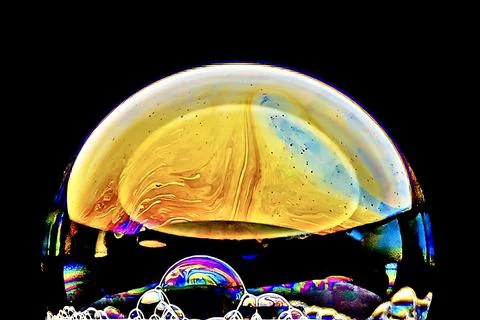 Closeup shot of a bubble with abstract patterns on a blackbackground Stock Photos