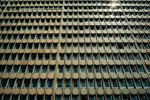 Closeup shot of a building with numerous rectangular windows, a background with Foto stock