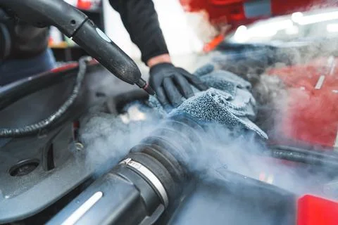 Closeup shot of car detailing process. Car washing cleaning engine. Cleaning car Stock Photos