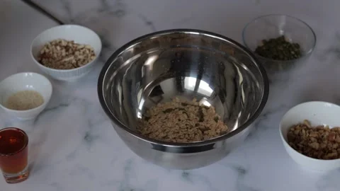 A closeup shot of a chef preparing an oat and nut mixture for breakfast grano Stock Footage 139260013