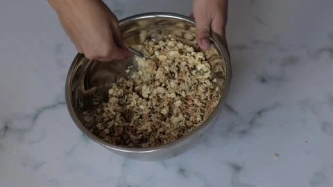 A closeup shot of a chef preparing an oat and nut mixture for breakfast grano Stock Footage 139260061