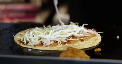 Closeup shot of a chef preparing Veg Frankie Roll Wrap, adding Sauces and Spices Stock Footage 169833692