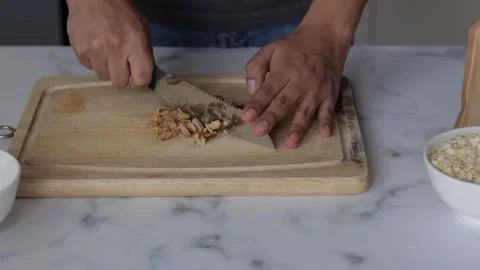 Closeup shot of a chef sorting walnuts on a cutting board Stock Footage 139260024