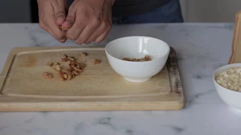 Closeup shot of a chef sorting walnuts on a cutting board Stock Footage 139260045