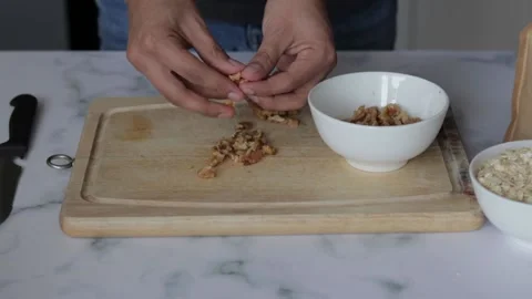 Closeup shot of a chef sorting walnuts on a cutting board Stock Footage 139260063