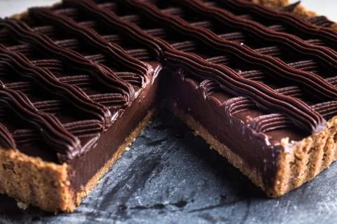 Closeup shot of a chocolate pie with a missing slice Stock Photos