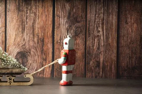 Closeup shot of a Christmas robot pulling a sled from behind Stock Photos
