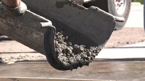 Closeup shot of concrete worker's hands pushing mix out of chute Video stock 39908724