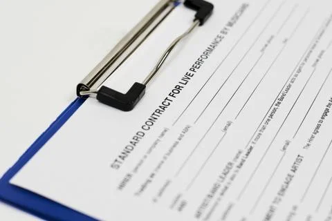 Closeup shot of a contract document attached to a blue folder Stock Photos