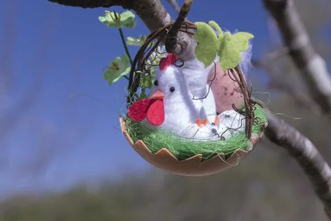 Closeup shot of a cute Easter craft hanging on a tree 写真素材
