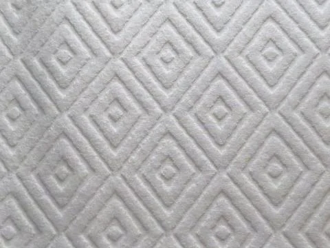 Closeup shot of a diamond shape pattern on white fluffy textile Stock Photos