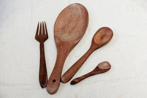 Closeup shot of different size spoons and a fork Stock Photos