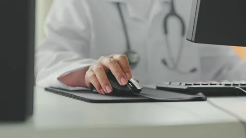 Closeup shot doctor's hand using computer working in hospital Stock Footage 196923136