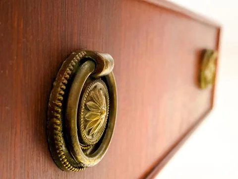 Closeup shot of a drawer with vintage knobs Stock Photos
