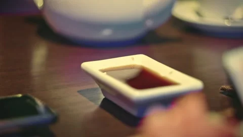 Closeup Shot of Eating modern type Sushi Rolls in Restaurant. Dipping susi roll Stock Footage 165494169