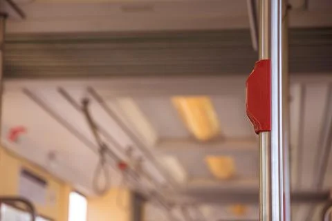 Closeup shot of an emergency stop button in the metro train Stock Photos