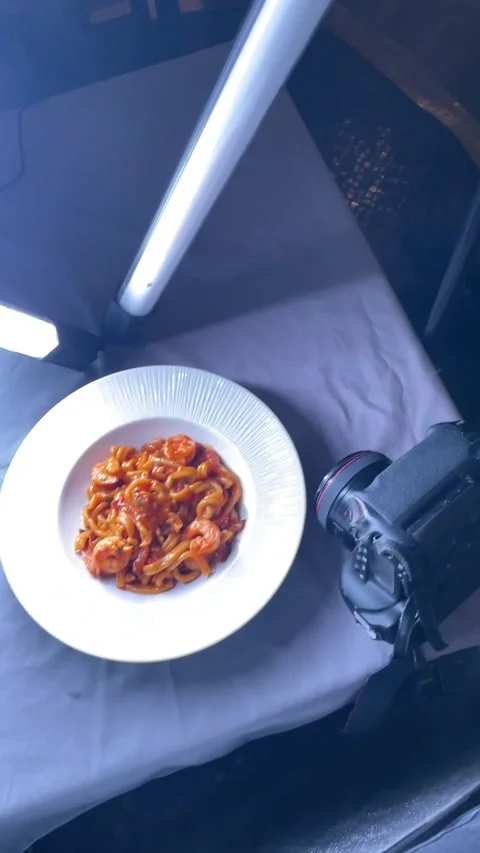 Closeup shot emphasizes sauce and garnish on shrimp pasta dish 스톡 동영상 335670952