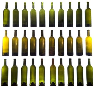 Closeup shot of empty wine bottles in a row on a white background Stock Photos