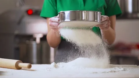 Closeup shot of experienced bakery chef sifting flour through sieve. Stock Footage 166594713