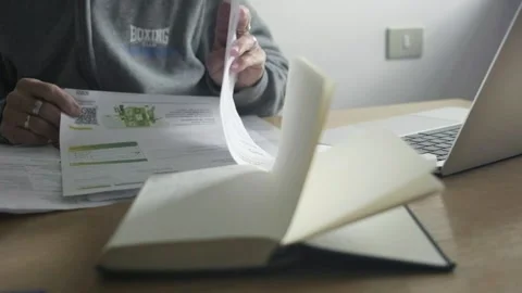 Closeup shot, female elder hands go through paper payment bills, desktop Stock Footage 274247121