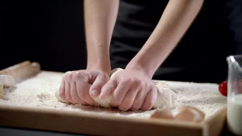Closeup Shot Of Female Hands Of Baker Kneading Dough In Flour On Wooden Board Video stock 170239660