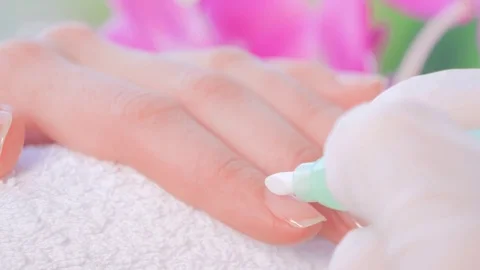 Closeup shot of female hands getting nail manicure on a towel 動画素材 79678313