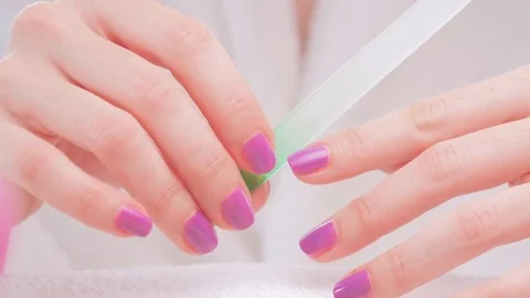 Closeup shot of female hands making nail manicure on a towel 動画素材 79837258