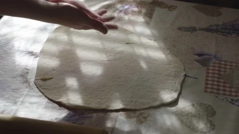 Closeup Shot Of Female Hands Rolling Dough On Table With A Rolling Pin at Home Stock Footage 166397015