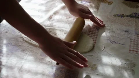 Closeup Shot Of Female Hands Rolling Dough On Table With A Rolling Pin at Home Stock Footage 166397089
