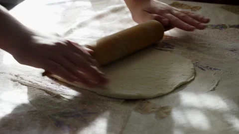 Closeup Shot Of Female Hands Rolling Dough On Table With A Rolling Pin at Home Stock Footage 166397181