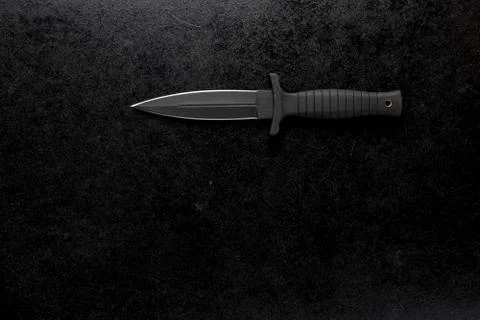 Closeup shot of a fixed sharp knife on a black background Foto stock
