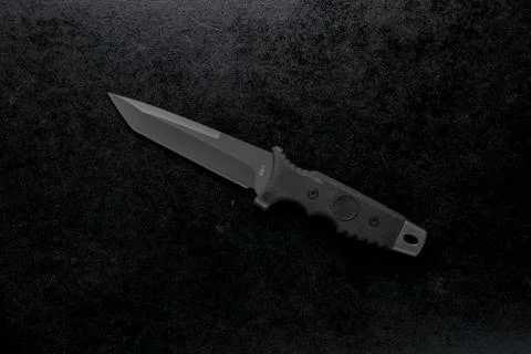 Closeup shot of a fixed sharp knife on a black background Stock Photos