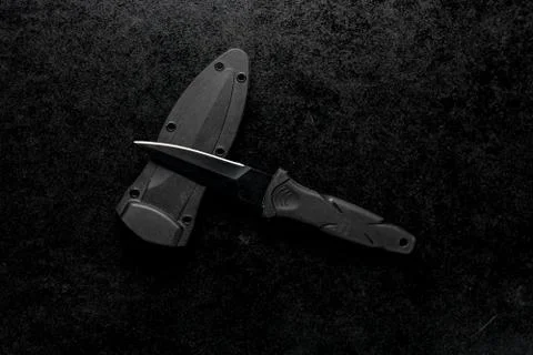 Closeup shot of a fixed sharp knife on a black background Stock Photos