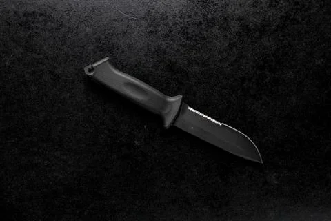 Closeup shot of a fixed sharp knife on a black background Stock Photos