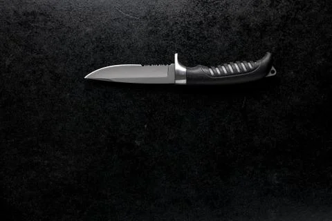 Closeup shot of a fixed sharp knife on a black background Stock Photos