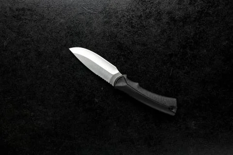 Closeup shot of a fixed sharp knife on a black background Stock Photos