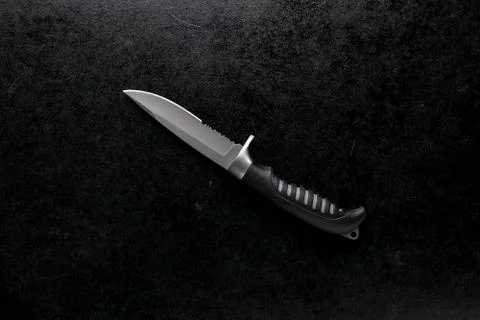 Closeup shot of a fixed sharp knife on a black background Stock Photos