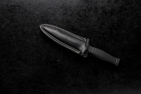 Closeup shot of a fixed sharp knife on a black background Stock Photos