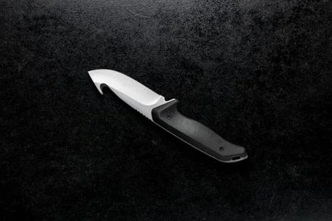 Closeup shot of a fixed sharp knife on a black background Stock Photos