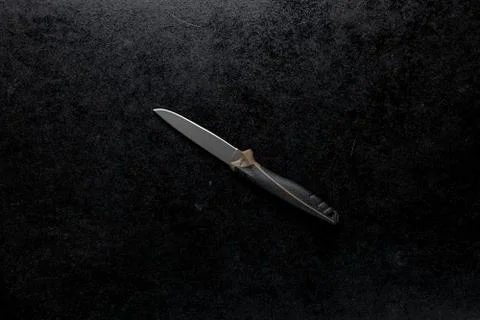 Closeup shot of a fixed sharp knife on a black background Stock Photos