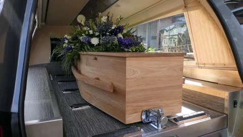 Closeup shot of a funeral casket in a hearse or chapel or burial at cemetery Stock Photos
