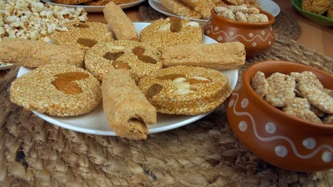 Closeup shot of gajak rolls, til patti, and rewri rotating on a turntable - L... Stock Footage 122307643