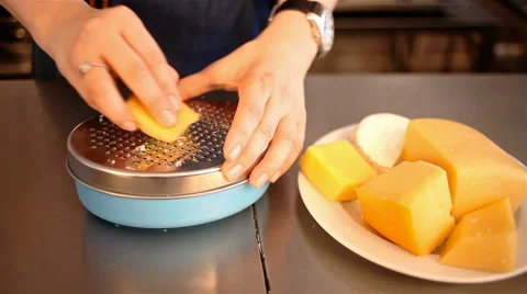 Closeup shot grating cheese with metall grater Stock Footage 65287527