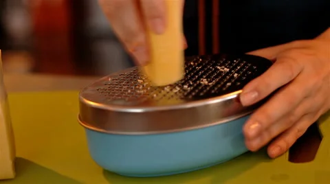 Closeup shot grating cheese with metall grater Stock Footage 65287675