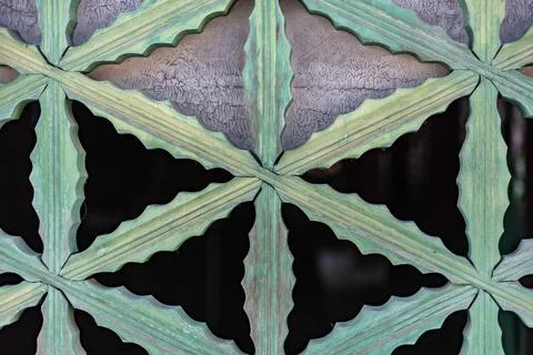 Closeup shot of green metallic pattern of gates Foto stock